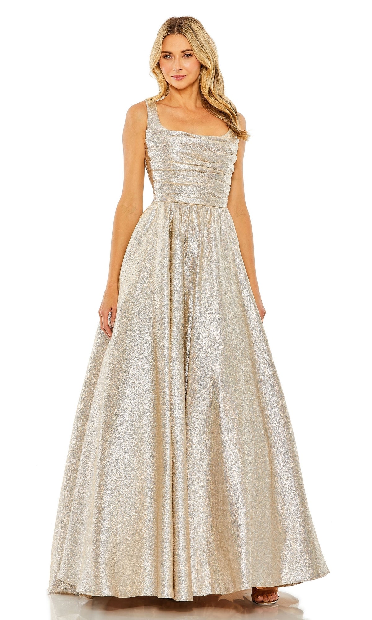A woman wears the Mac Duggal 68349 Long Glitter Prom Ball Gown—a sleeveless, floor-length metallic silver dress with a fitted bodice and full A-line skirt, perfect for formal occasions.